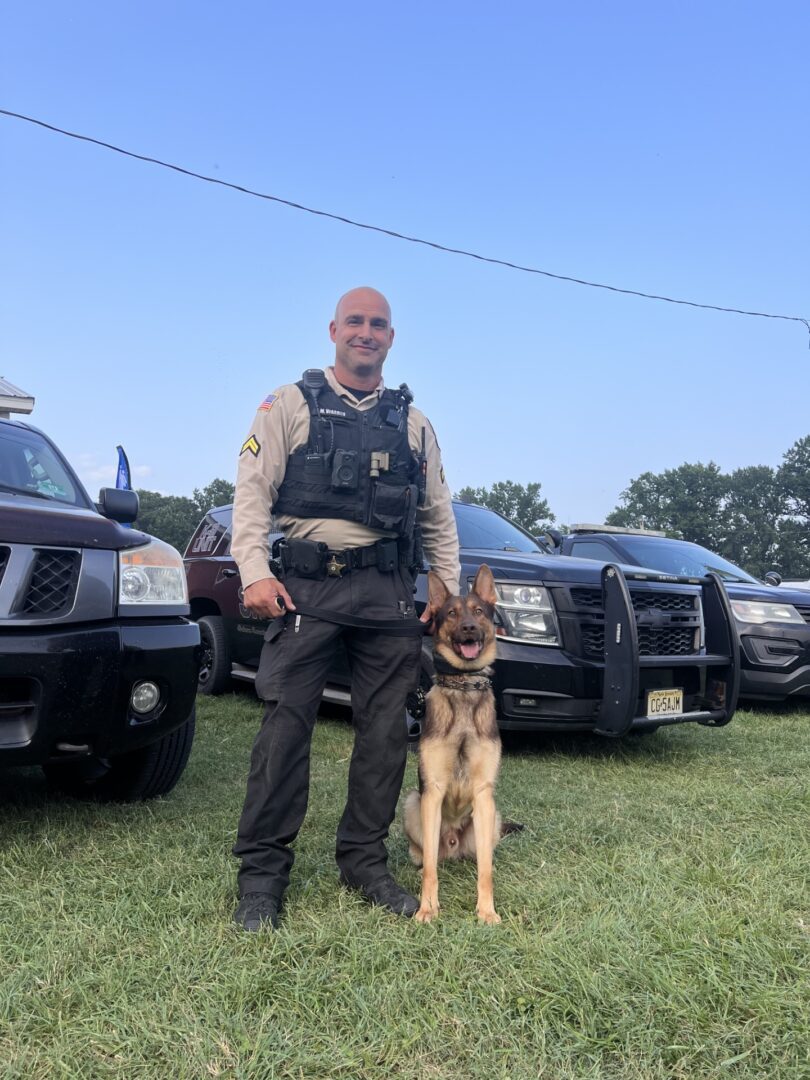 Police K9 with handler and patrol vehicle