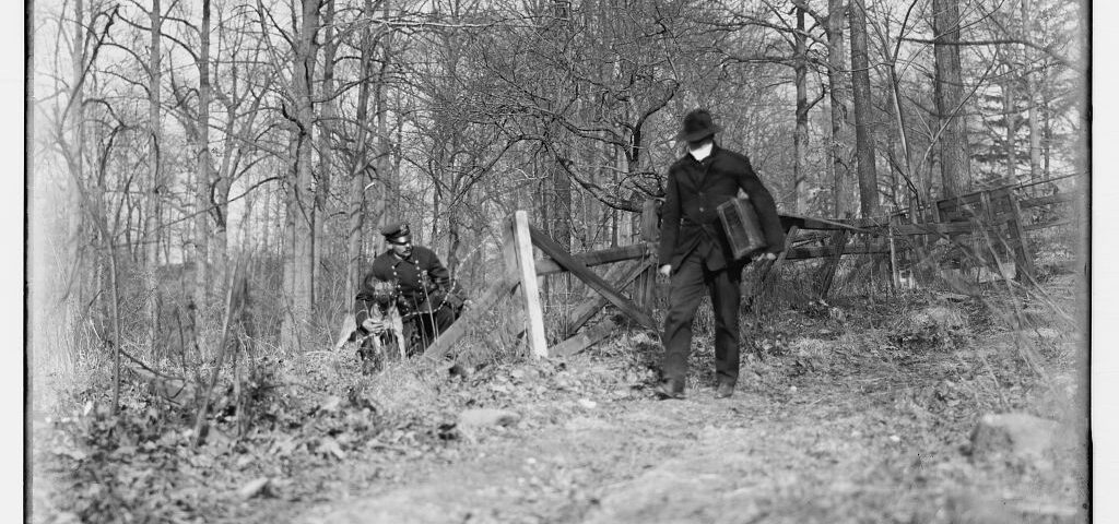 Historic 1912 photo of an NYPD police K9 unit officer and his dog on patrol in New York City